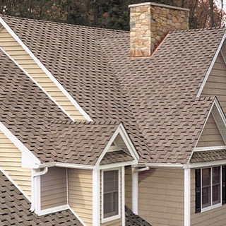 image of new roof on yellow house, brown roof