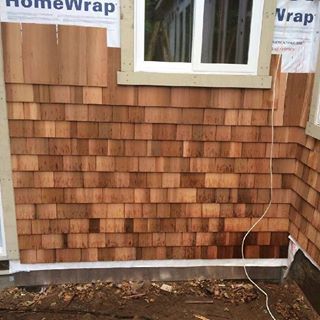 image of process of putting wood shingles on house